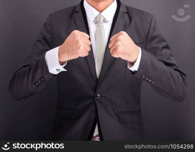 Young businessman with no boxing gloves isolated on black background