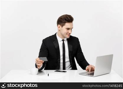 Young businessman with notebook and credit card isolated over white background.. Young businessman with notebook and credit card isolated over white background