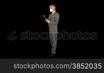 Young businessman with protective glasses and mask taking notes, against black