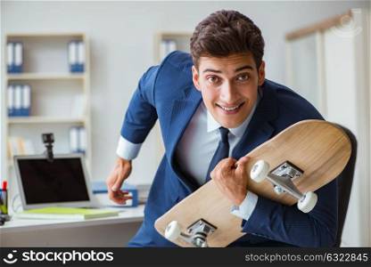Young businessman with skate in office in sports concept