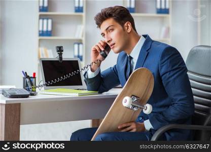 Young businessman with skate in office in sports concept. The young businessman with skate in office in sports concept