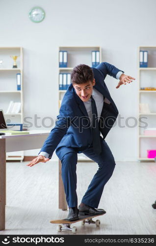 Young businessman with skate in office in sports concept