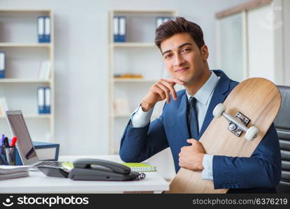 Young businessman with skate in office in sports concept