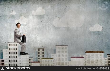 Young businessman with suitcase sitting on roof of building. Taking break from office