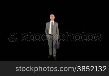 Young businessman with umbrella, against black