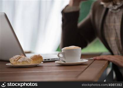 Young businessman working at cafe using laptop