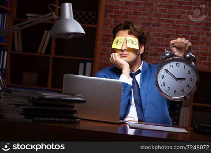 Young businessman working in the office at night 