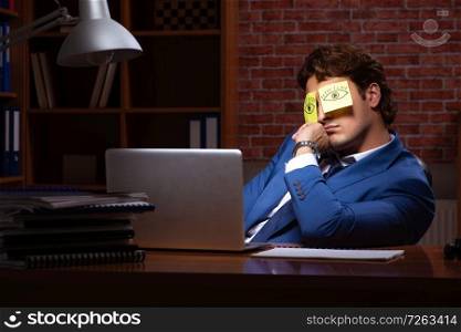 Young businessman working in the office at night . The young businessman working in the office at night 