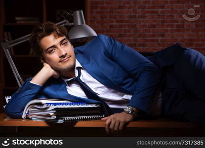 Young businessman working in the office at night 