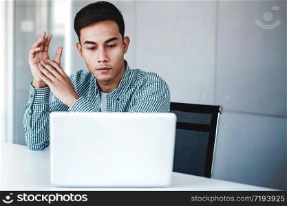 Young Businessman Working on Computer Laptop in Office. Sitting on Desk, Concentrated Thoughtful Men