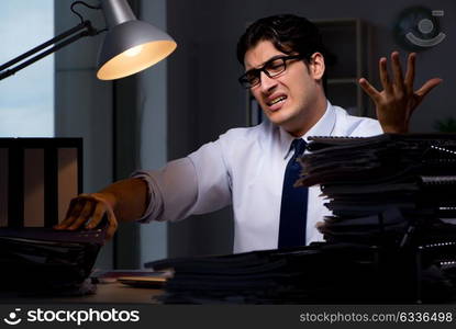 Young businessman working overtime late in office