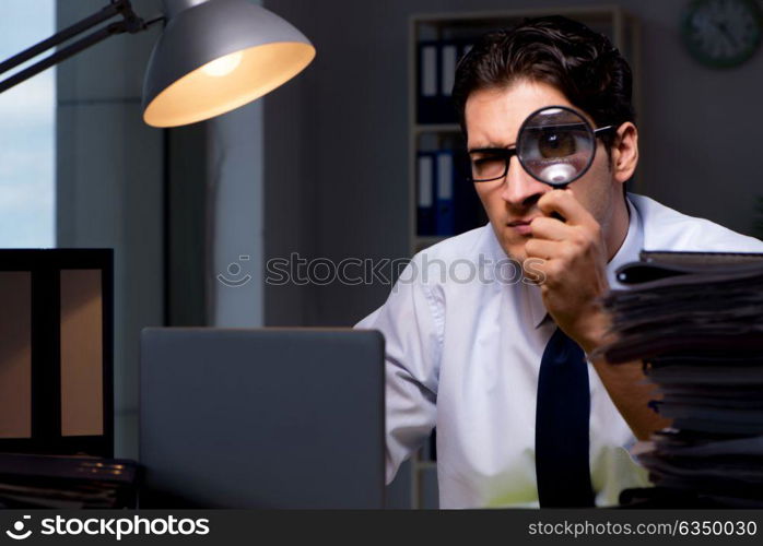 Young businessman working overtime late in office