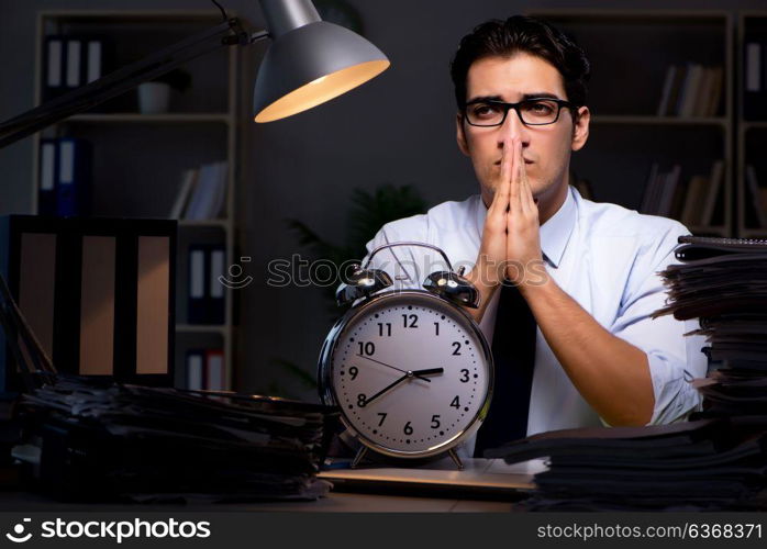 Young businessman working overtime late in office