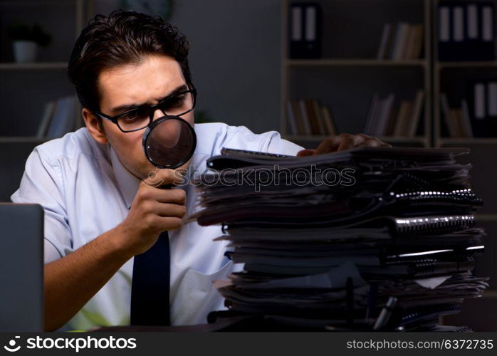 Young businessman working overtime late in office