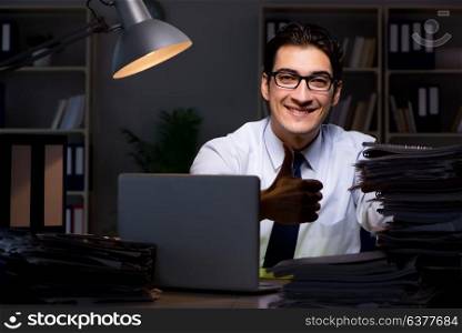 Young businessman working overtime late in office