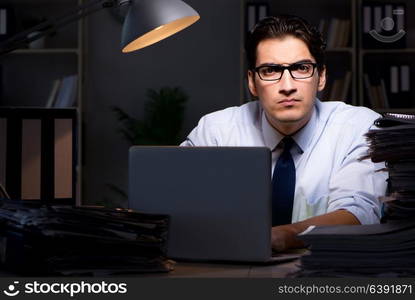 Young businessman working overtime late in office