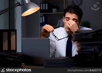 Young businessman working overtime late in office