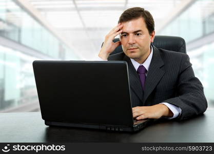 young businessman working with is laptop, at the office