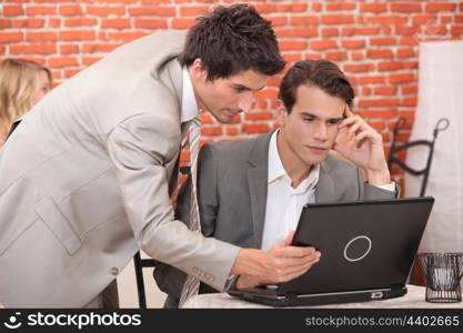 Young businessmen connecting with laptop computer