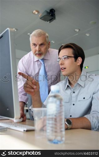 Young businessmen explaining point to boss