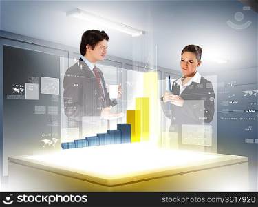 young businesspeople looking at graph of high-tech image