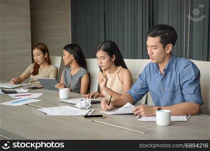 young businesspeople, man and woman, working in the meeting room, selective focus
