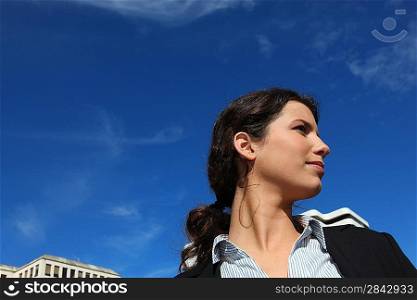 Young businesswoman against a blue sky