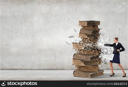Young businesswoman and pile of old books. Fight for education