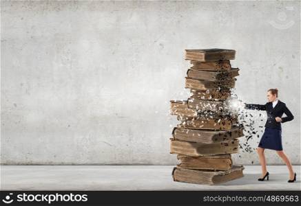 Young businesswoman and pile of old books. Fight for education