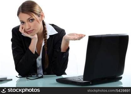 young businesswoman before laptop feeling weary