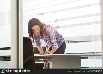 Young businesswoman busy in office