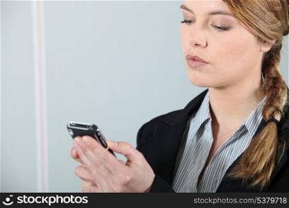 Young businesswoman checking phone.