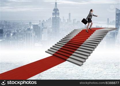 Young businesswoman climbing stairs and red carpet