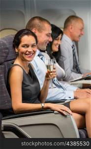 Young businesswoman enjoy flight glass champagne airplane cabin travel passenger