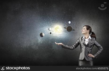 Young businesswoman exploring planets of sun system. Mysteries of space