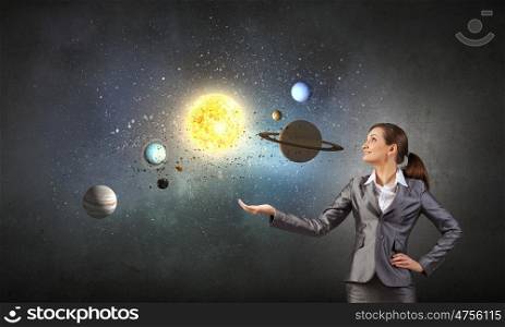 Young businesswoman exploring planets of sun system. Mysteries of space