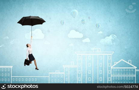 Young businesswoman flying high in sky on umbrella. Woman fly on umbrella