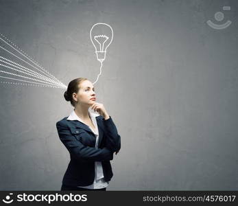 Young businesswoman has an idea. Young thoughtful woman and ideas coming out of her head