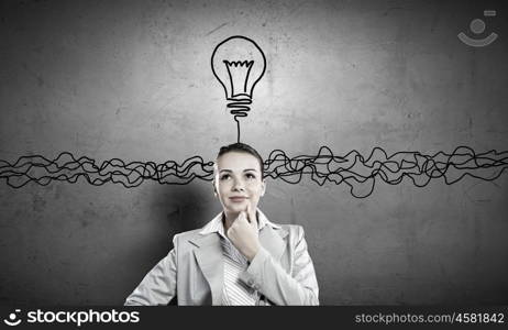 Young businesswoman has an idea. Young thoughtful woman and ideas coming out of her head