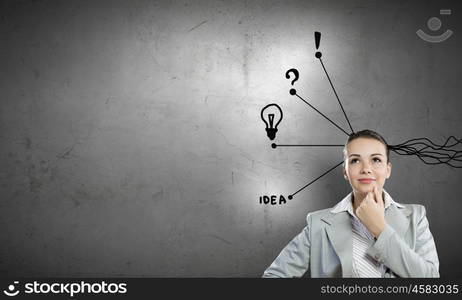 Young businesswoman has an idea. Young thoughtful woman and ideas coming out of her head