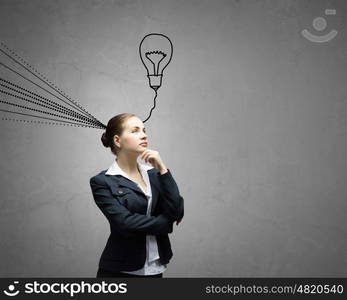 Young businesswoman has an idea. Young thoughtful woman and ideas coming out of her head