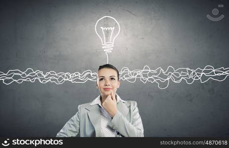 Young businesswoman has an idea. Young thoughtful woman and ideas coming out of her head