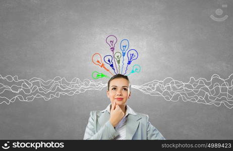 Young businesswoman has an idea. Young thoughtful woman and ideas coming out of her head