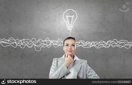 Young businesswoman has an idea. Young thoughtful woman and ideas coming out of her head