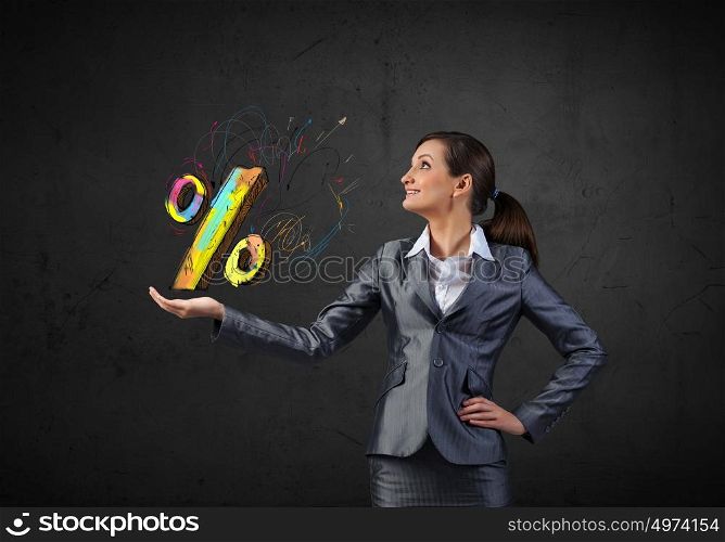 Young businesswoman holding percentage symbol in palm. Sales and percentage