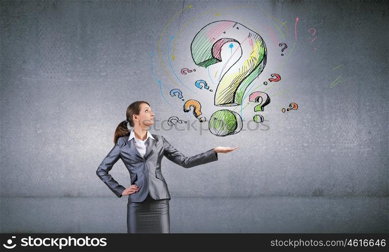Young businesswoman holding question mark in palm. Have question