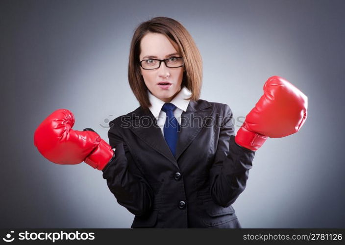 Young businesswoman in boxing concept