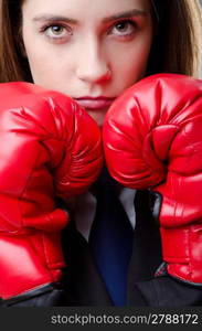 Young businesswoman in boxing concept