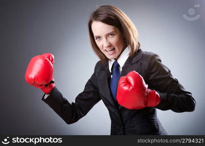 Young businesswoman in boxing concept