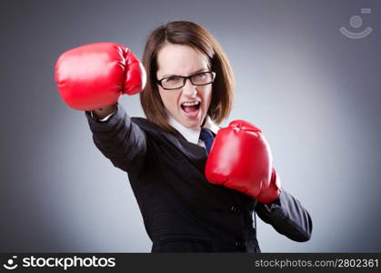 Young businesswoman in boxing concept